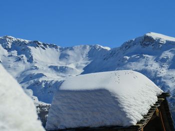 Scenic view of snowcapped mountains against clear blue sky