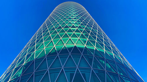 Low angle view of modern building against clear blue sky