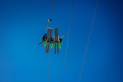 Low angle view of wind turbine against clear blue sky