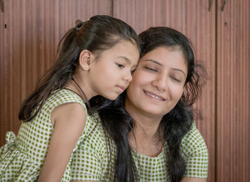 Portrait of a smiling girl with mother