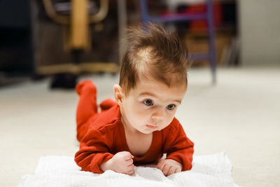 Portrait of cute baby girl on bed