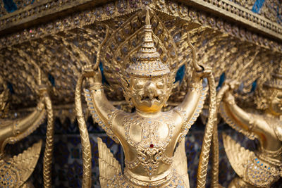 Close-up of buddha statue against temple