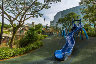 View of playground against trees in park