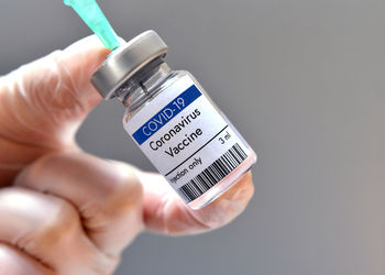 Coronavirus vaccine vial bottle in research laboratory. close-up view