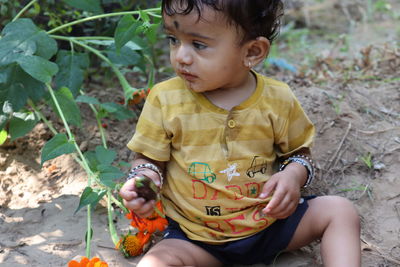 Cute boy sitting outdoors