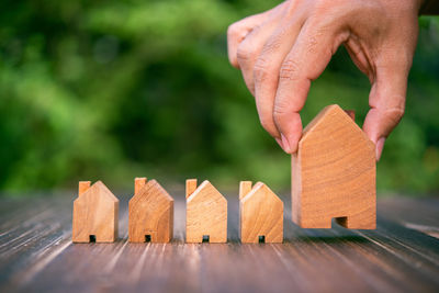 Cropped hand of person holding model house