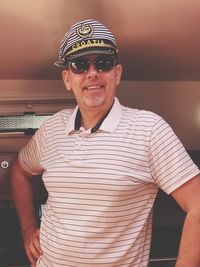 Portrait of smiling mature navy officer standing on ship