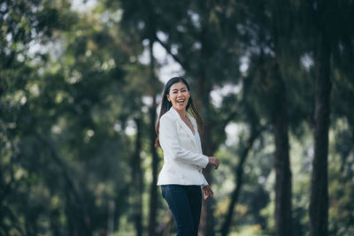 Portrait of a smiling young woman standing outdoors