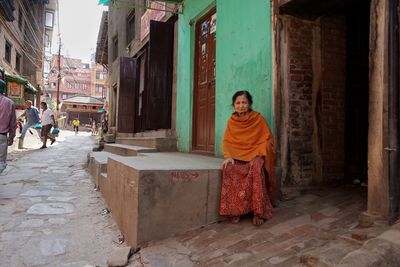 Woman standing by building