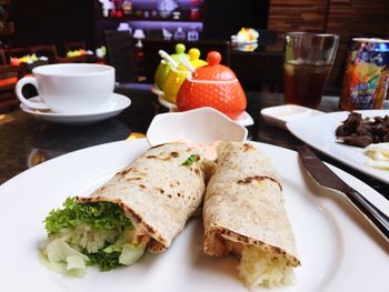 Burrito and drinks served on table in caf