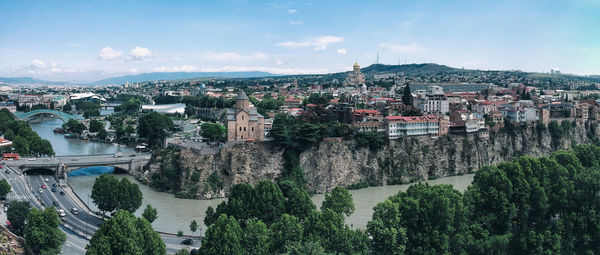 High angle view of townscape by river against sky