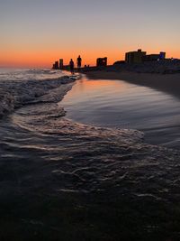 Scenic view of beach against sky during sunset