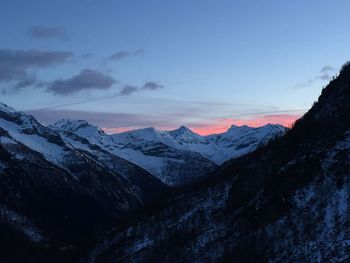 Scenic view of snowcapped mountains against sky during sunset