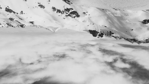 Low angle view of snowcapped mountain against sky