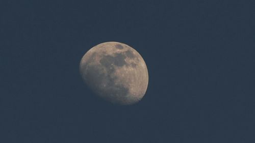 Low angle view of moon against sky at night