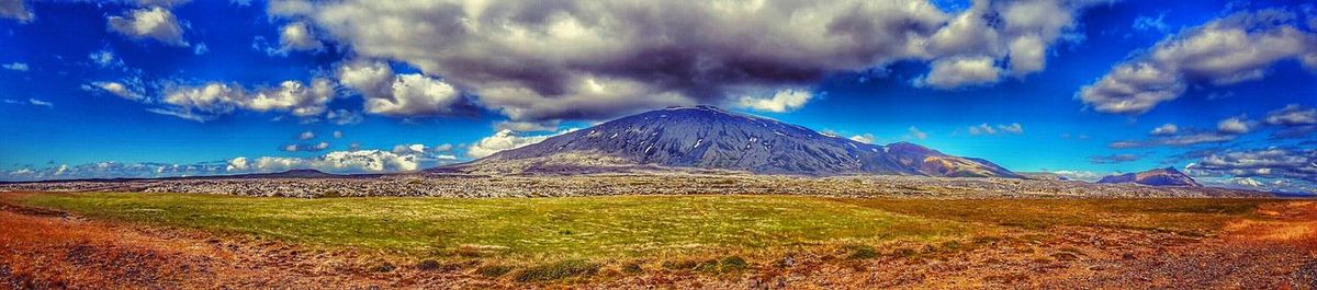 Scenic view of mountains against cloudy sky