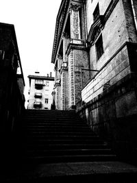 Low angle view of staircase in city against sky