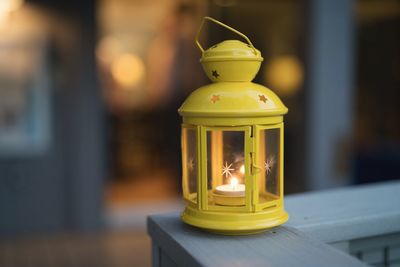 Close-up of illuminated lamp on table