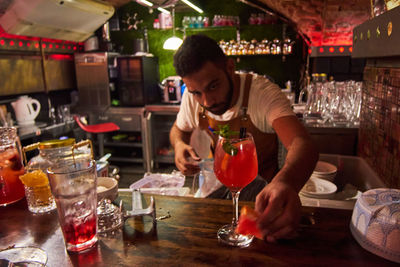 Friends toasting drinks on table