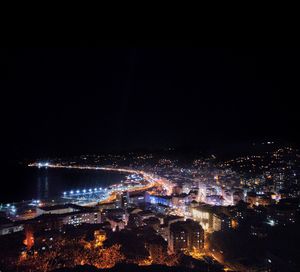 High angle view of illuminated city buildings at night