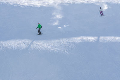 People skiing on snowcapped mountain