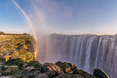 Panoramic view of waterfall against sky