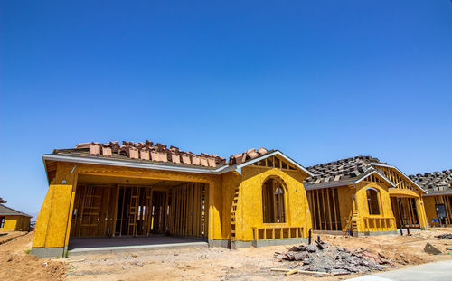 Built structures against clear blue sky