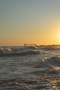 Scenic view of sea against clear sky during sunset