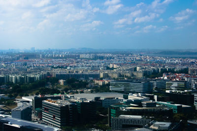 High angle view of buildings in city against sky