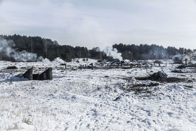 Scenic view of field against sky during winter