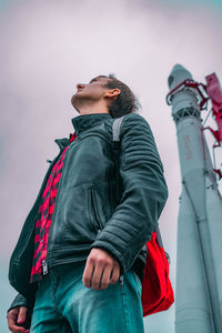 Low angle view of young man looking away