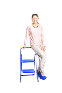 Portrait of a smiling young woman over white background