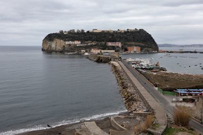 Scenic view of sea by buildings against sky