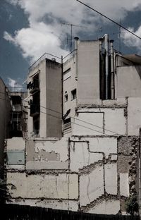 Low angle view of building against cloudy sky