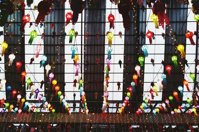 Low angle view of multi colored lights hanging in building