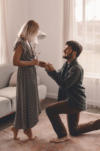 Side view of couple standing at home