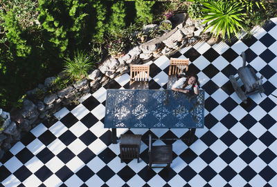 High angle portrait of woman sitting at outdoor cafe