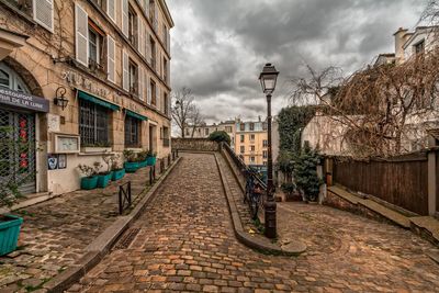 Street amidst buildings against sky