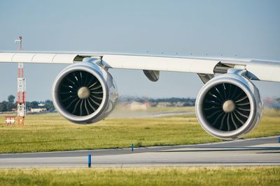 Airplane on runway against clear sky