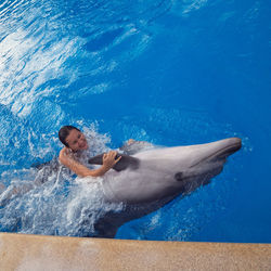 Side view of man swimming in pool