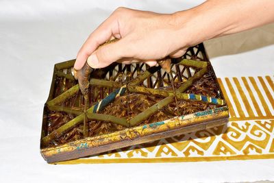 Midsection of person holding ice cream cone on table