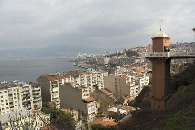 High angle view of buildings by sea against sky