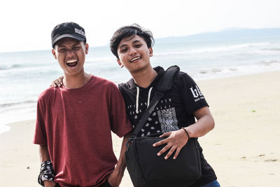 Portrait of smiling young couple on beach