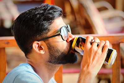 Close-up of man drinking from can