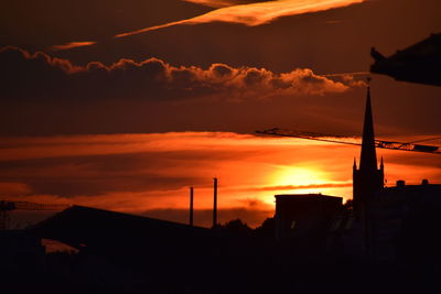 Low angle view of silhouette buildings against sky during sunset