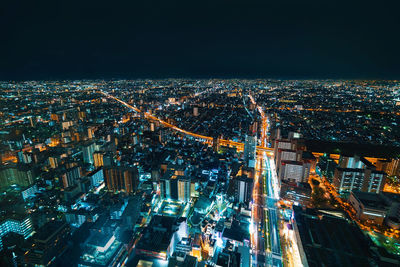 High angle view of city lit up at night