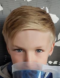 Close-up portrait of boy drinking water