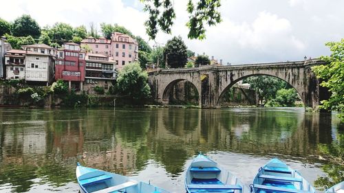 Arch bridge over river against sky