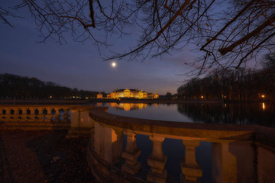 Bridge over river against sky at dusk