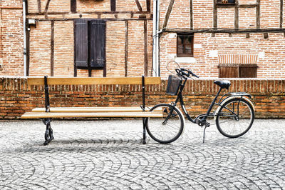 Bicycle on street against building in city